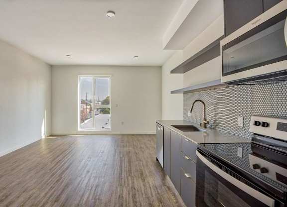 A kitchen with a stove top oven and microwave.at Catalina West Adams, California, 90016
