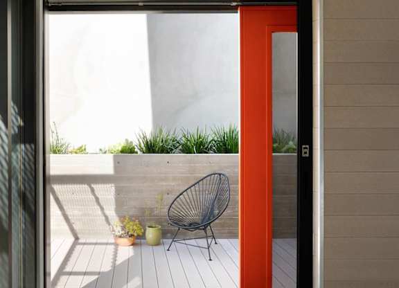 A red door opens to a balcony at 810 Ashland, Santa Monica, CA
