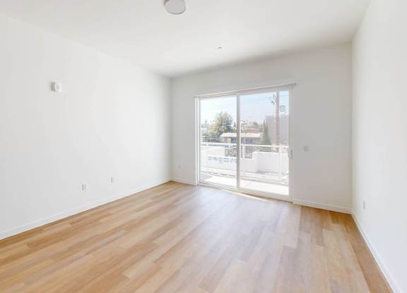 A room with wooden flooring and a sliding glass door.at The Dillon II at Silver Lake, Los Angeles, CA 90026
