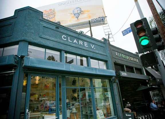 A Clarav storefront with a green awning and a pedestrian crossing sign.at The Dillon II at Silver Lake, Los Angeles