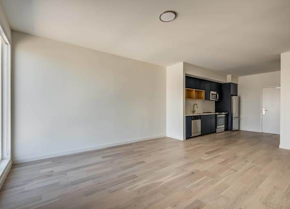 A room with wooden flooring and white walls.at Junction 4121, Los Angeles California
