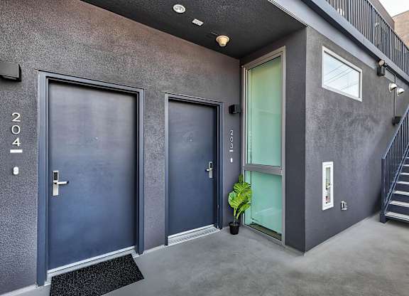 A modern house with a staircase leading to the upper floor.at 5135 W Adams, California, 90016
