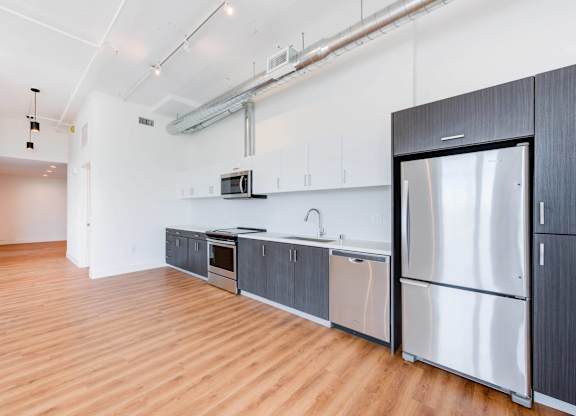 A kitchen with wooden floors and stainless steel appliances.at 2231 S Western, Los Angeles, CA 90018