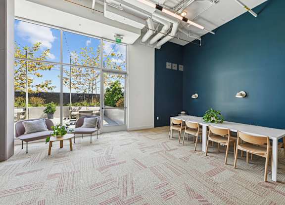 A room with a long table and chairs with a view of the outside.at 2221 S Western, Los Angeles, CA 90018