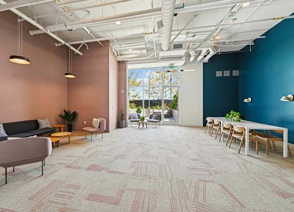 A room with a carpeted floor and a long table with chairs.at 2221 S Western, Los Angeles, CA