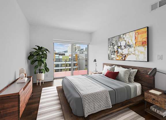 A bedroom with a large bed and a view of the city.