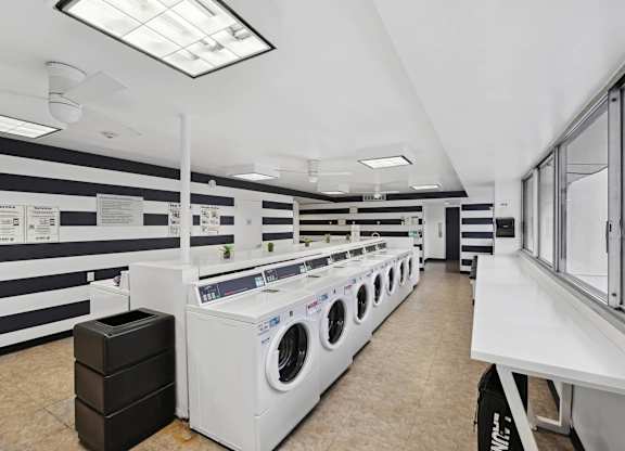A laundromat with rows of washers and dryers.