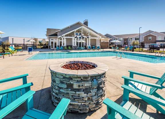 Pool area with stone fire pit at Leland Station Apartments, North Carolina, 28451