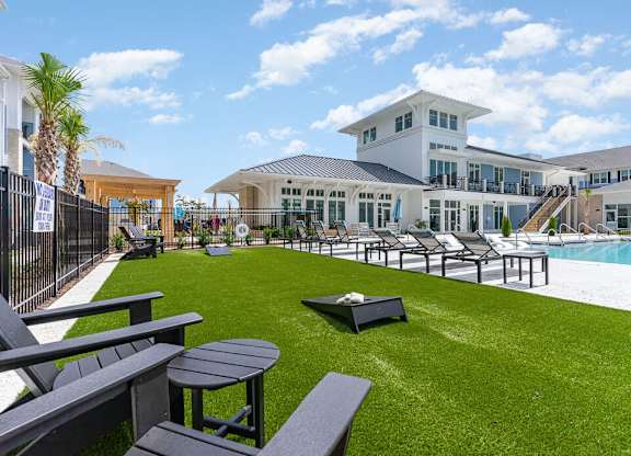 A large white building with a pool in front. at The Banks at Bridgewater Apartments, Little River, SC