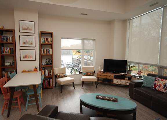 A living room with a white table and a couch.