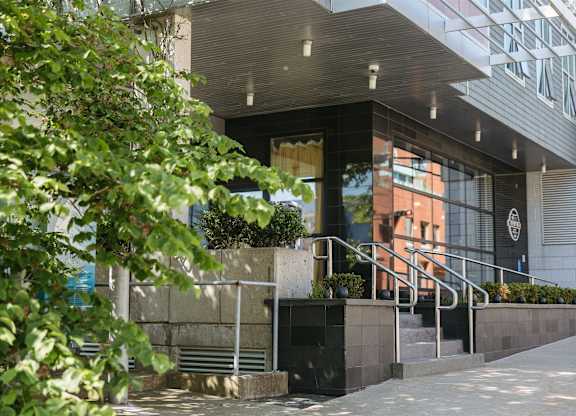 A building with a black and white logo on the wall.