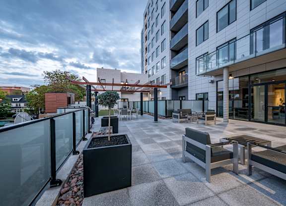 A modern patio area with benches and a table.