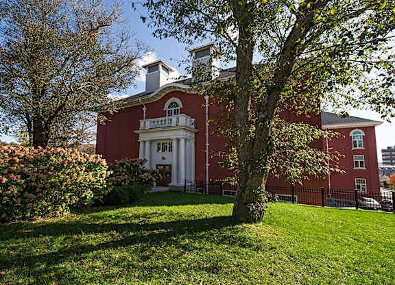 A red building with a white door and windows.