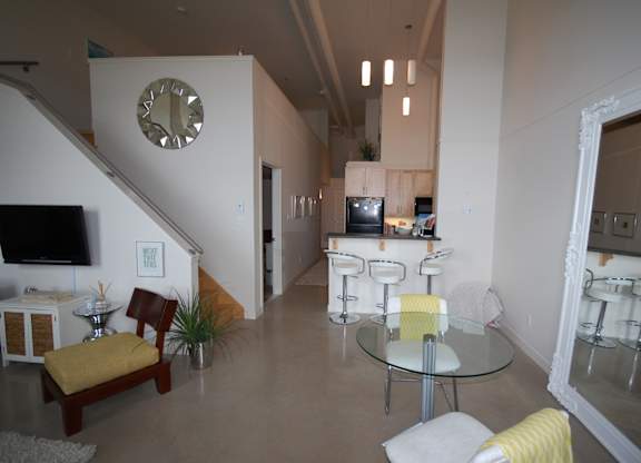 A living room with a glass table and chairs.