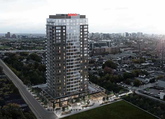 A tall building with a red sign on the top of it.