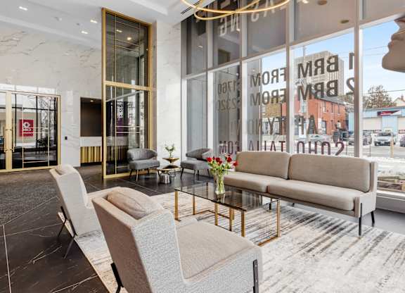 A modern living room with a large window and a view of the street.