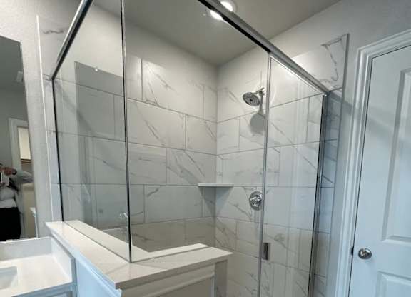 Bathroom with Marble Tile Shower at Cottages at Beltmill Apartments, Saginaw