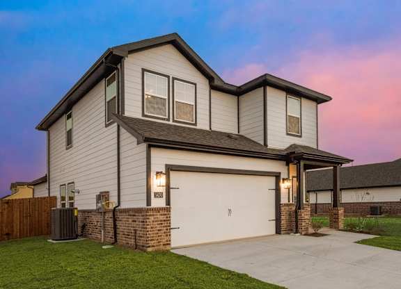 A Modern House With a Garage at Cottages at Beltmill Apartments, Saginaw, TX, 76131