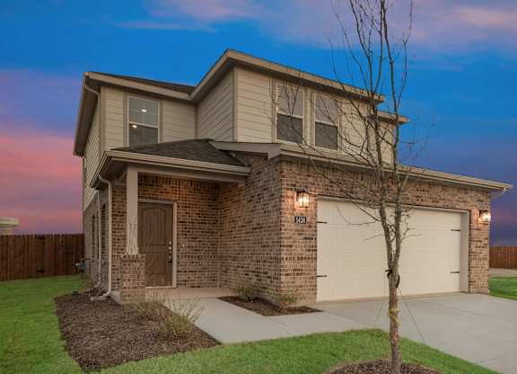 A House With a Brown Brick Exterior at Cottages at Beltmill Apartments, Saginaw, TX