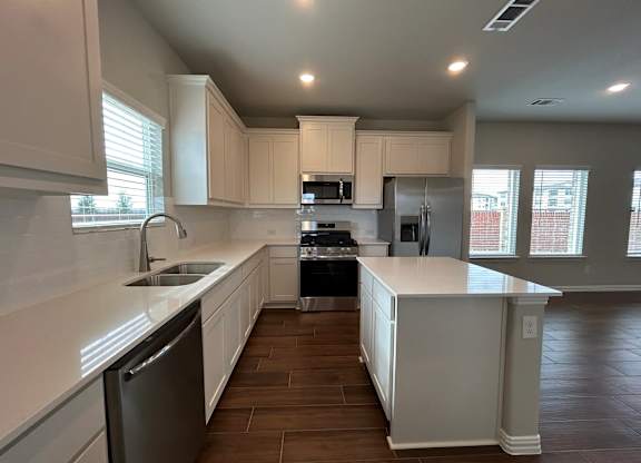 Kitchen with a Black Dishwasher at Cottages at Beltmill Apartments, Saginaw