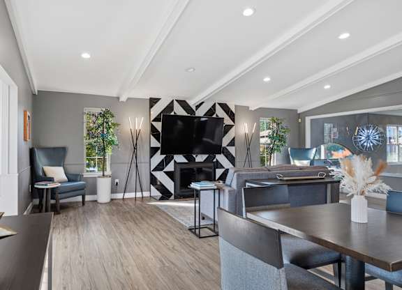A modern living room with a fireplace and a TV.