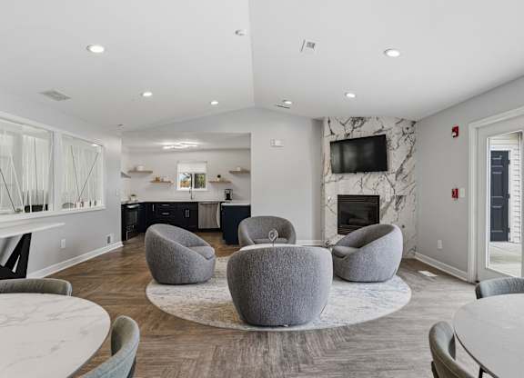 A modern living room with a fireplace and a TV mounted on the wall.