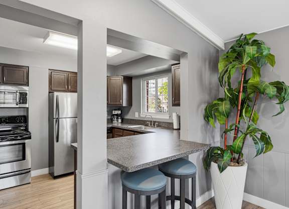 A kitchen with a stainless steel refrigerator and oven.
