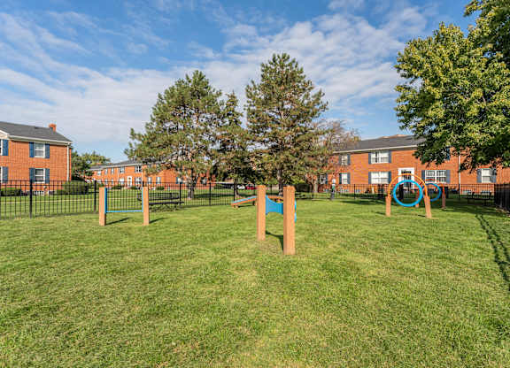 A playground with a blue ring on a pole.