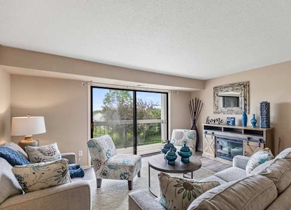 A living room with a couch, chairs, and a coffee table.