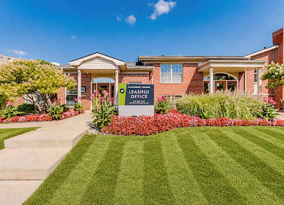 A sign in front of a house that says Leasing Office.