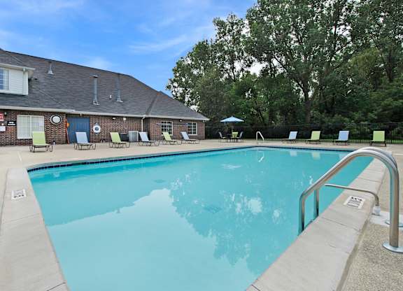 A large swimming pool with a metal ladder on the side.