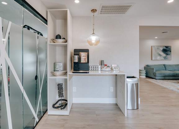A modern kitchen with a glass door refrigerator and a white countertop.