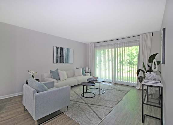 A living room with a grey couch and a coffee table.