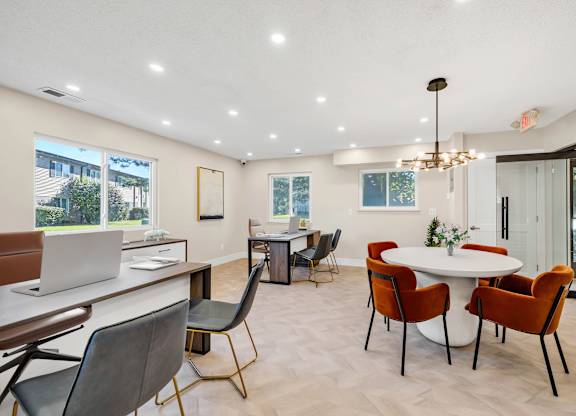 A modern clubhouse with a white table and chairs.