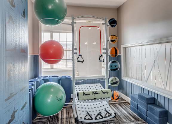 A gym with a green and red ball hanging from the ceiling.
