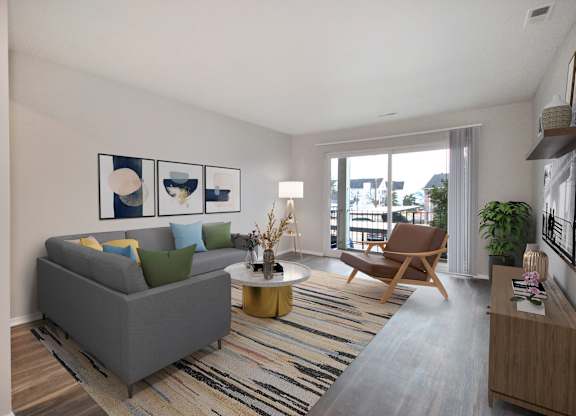 A living room with a grey couch, a wooden chair, a coffee table, and a striped rug.