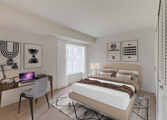 A bedroom with a bed, desk, and chair.