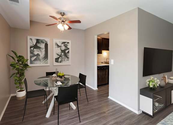A dining room with a glass table and chairs.