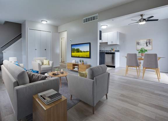 A living room with a grey couch, a coffee table, and a television.