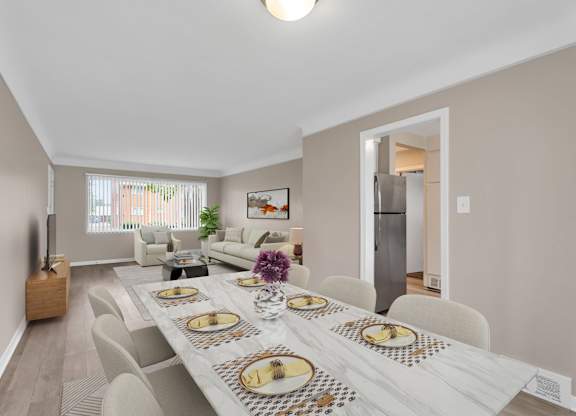 A dining room with a long table set for a meal.