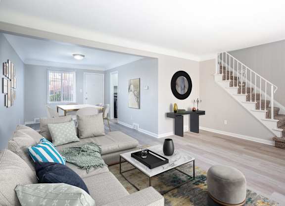 A living room with a grey couch and a coffee table.