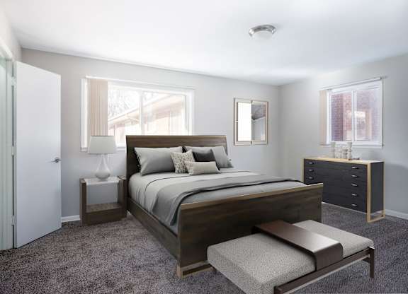 A bedroom with a large bed and a bench.