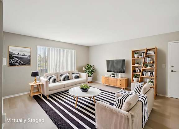 A living room with a striped couch and a coffee table.