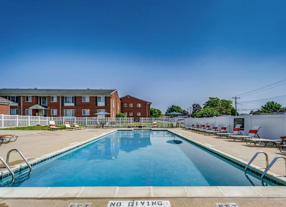 A pool with a no diving sign in the foreground.