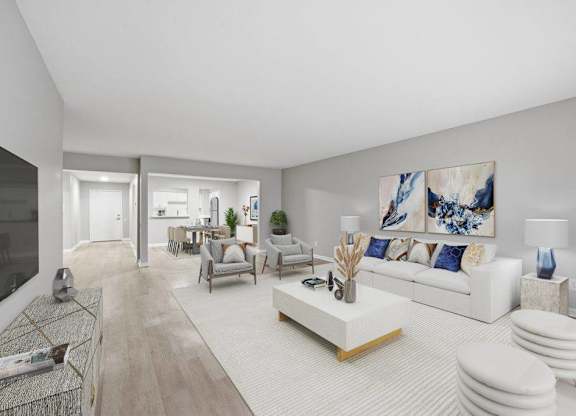 A modern living room with a white sofa and a large painting on the wall.