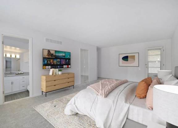 A bedroom with a bed, a dresser, and a painting on the wall.