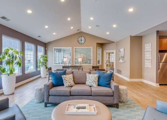 A living room with a grey couch and a coffee table.