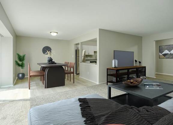 A modern living room with a black couch and a television.