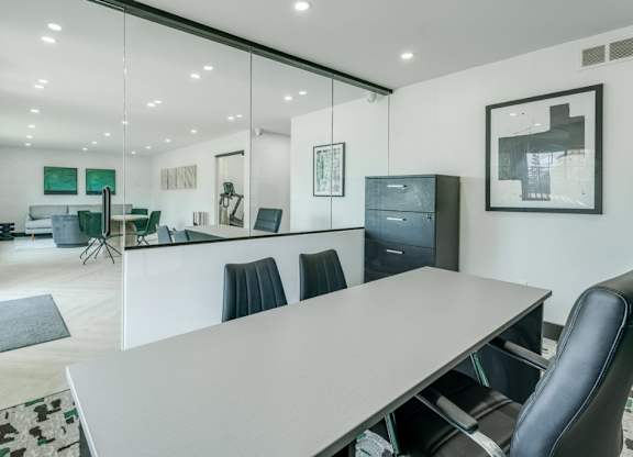 A conference room with a long table and chairs.