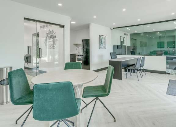 A conference room with a table and chairs.